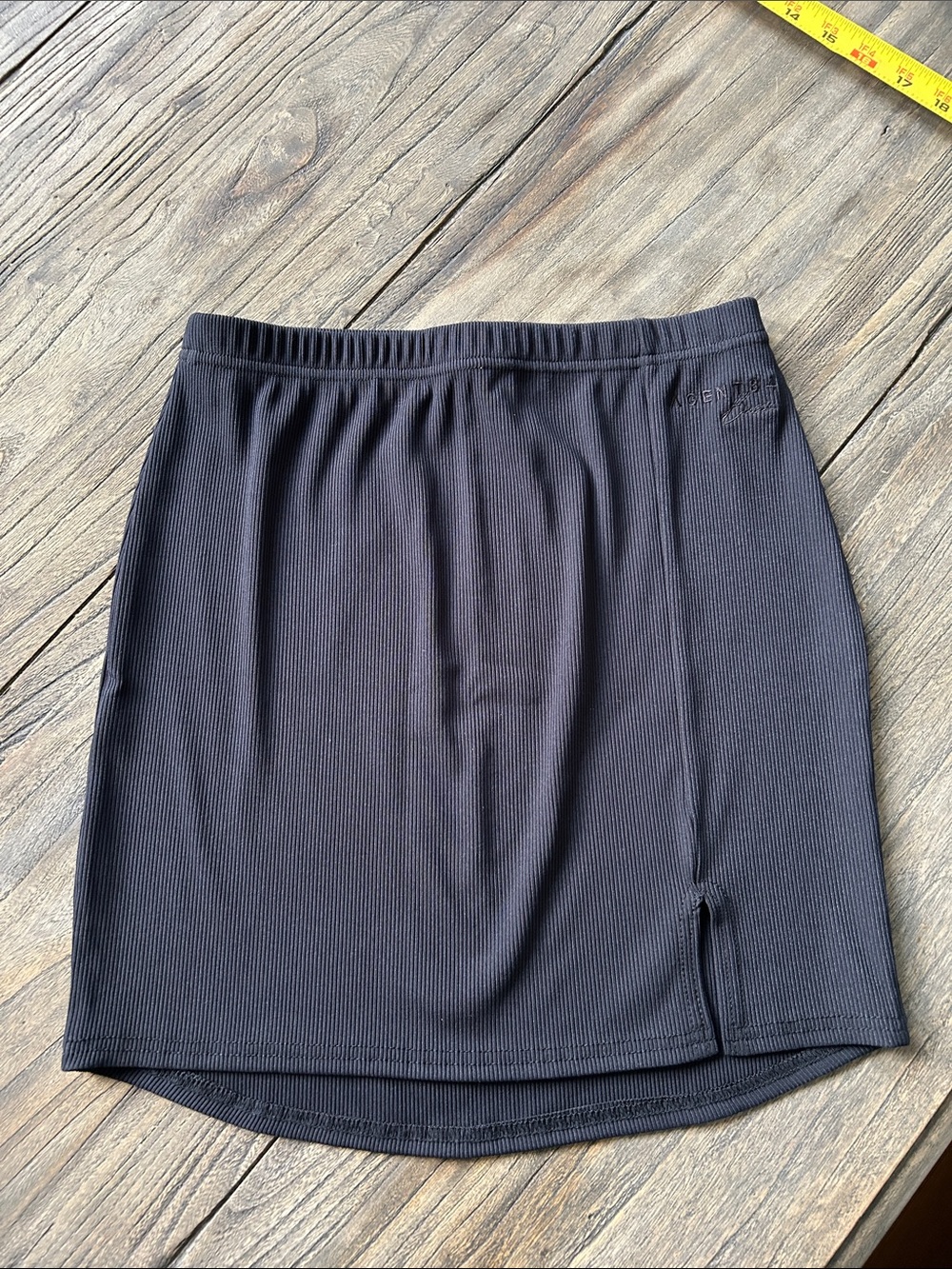 Sleek Black Ribbed Mini Skirt with Subtle Front Slit
